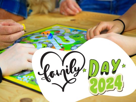 Family playing board game celebrating Family Day 2024